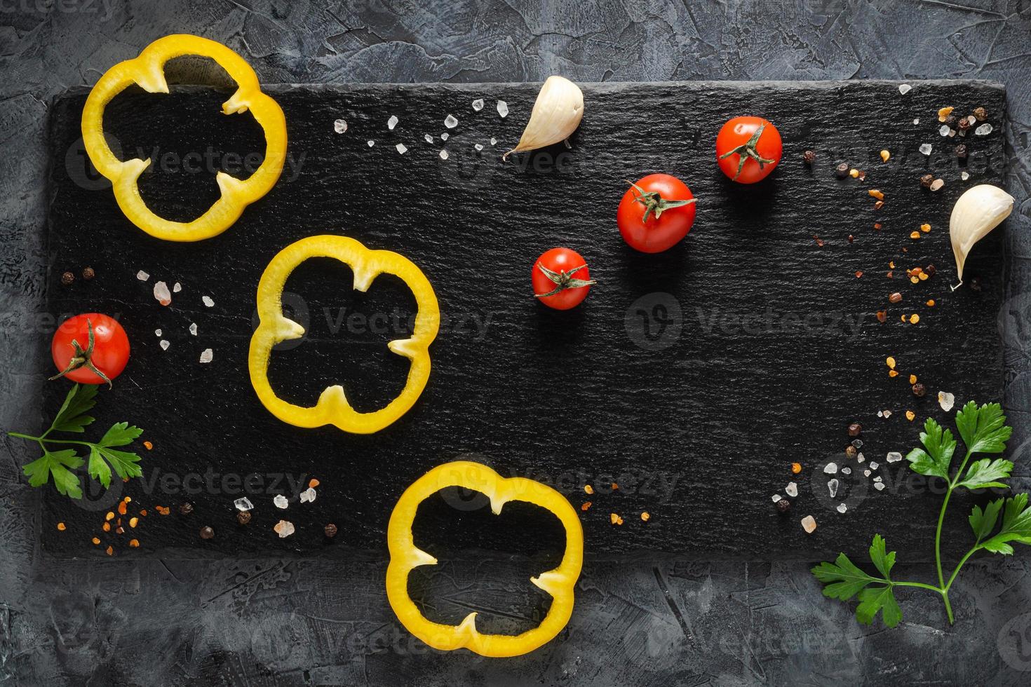 Colorful vegetables composition with yellow pepper, tomatoes, greens. Top view. photo