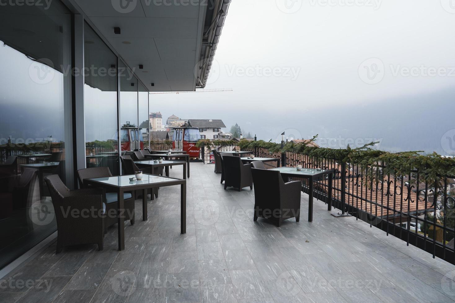 Chairs and tables at outdoor restaurant in luxury hotel photo