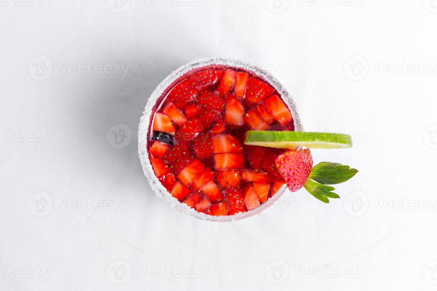 Top view of frozen strawberry and lime margarita. Valentine's dessert recipe. Strawberry juice. photo