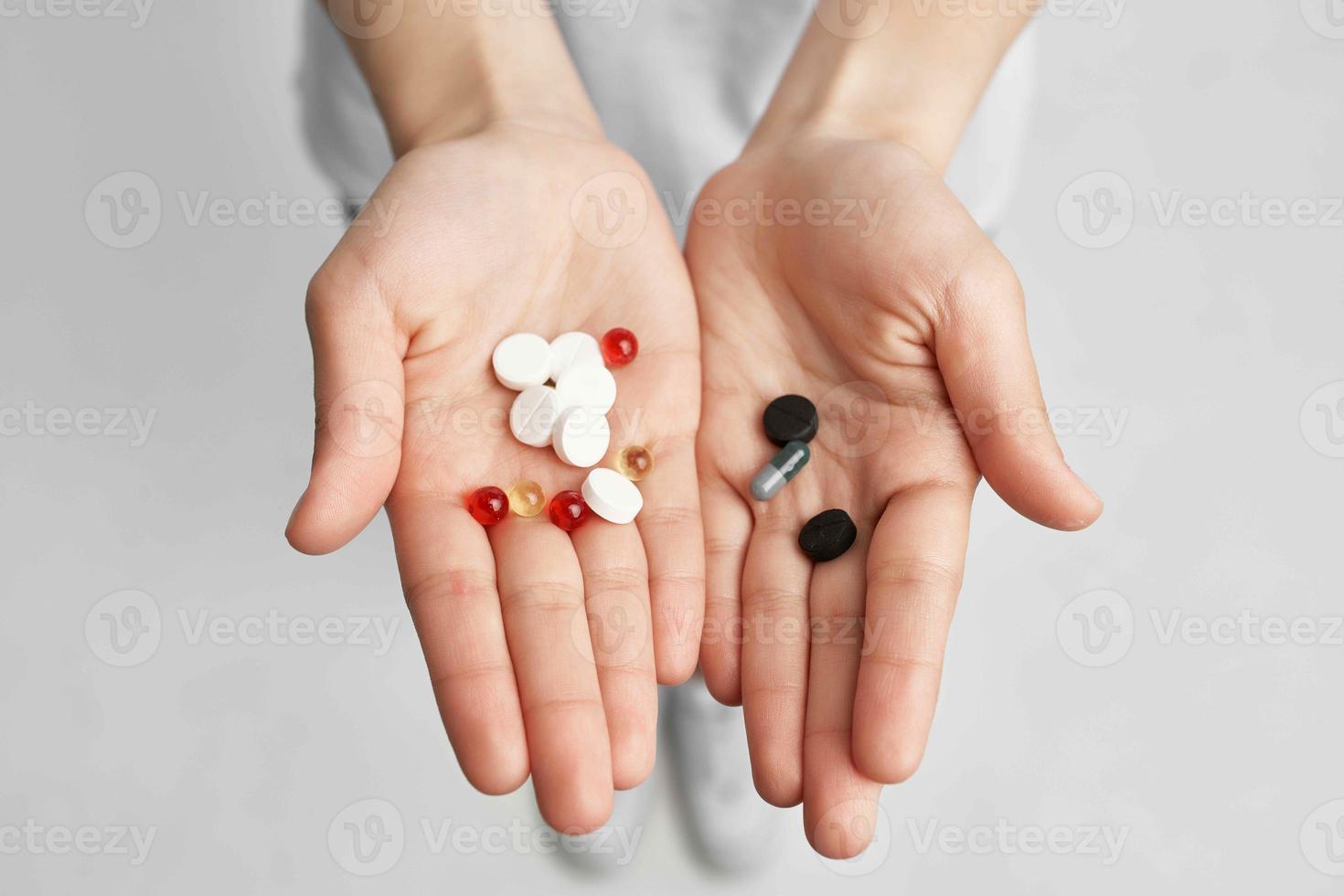 sick woman pills in hand pain reliever light background photo