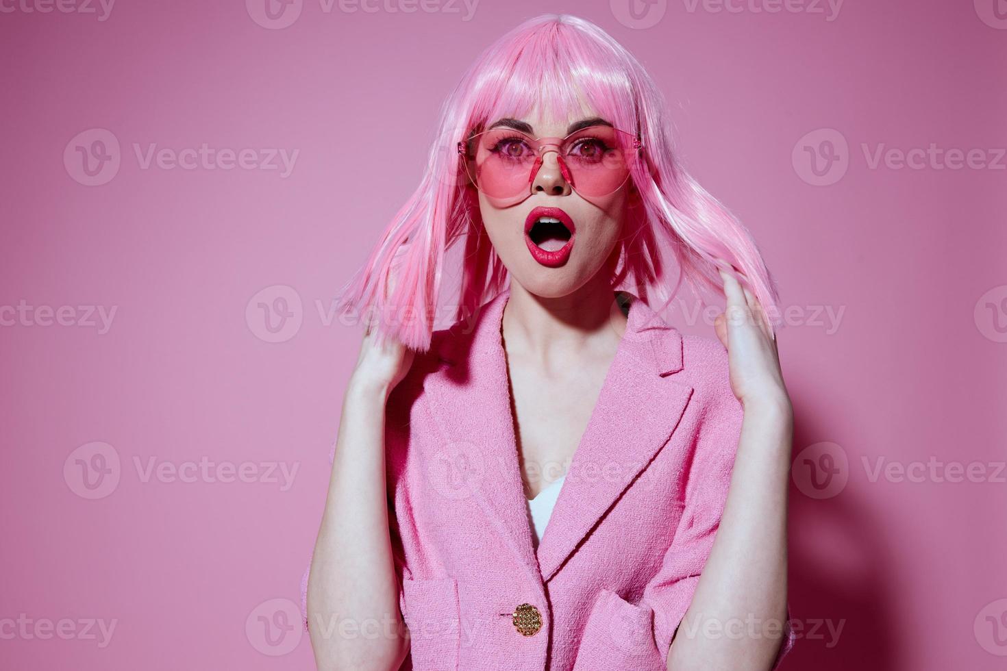 Portrait of a young woman bright makeup pink hair glamor stylish glasses color background unaltered photo