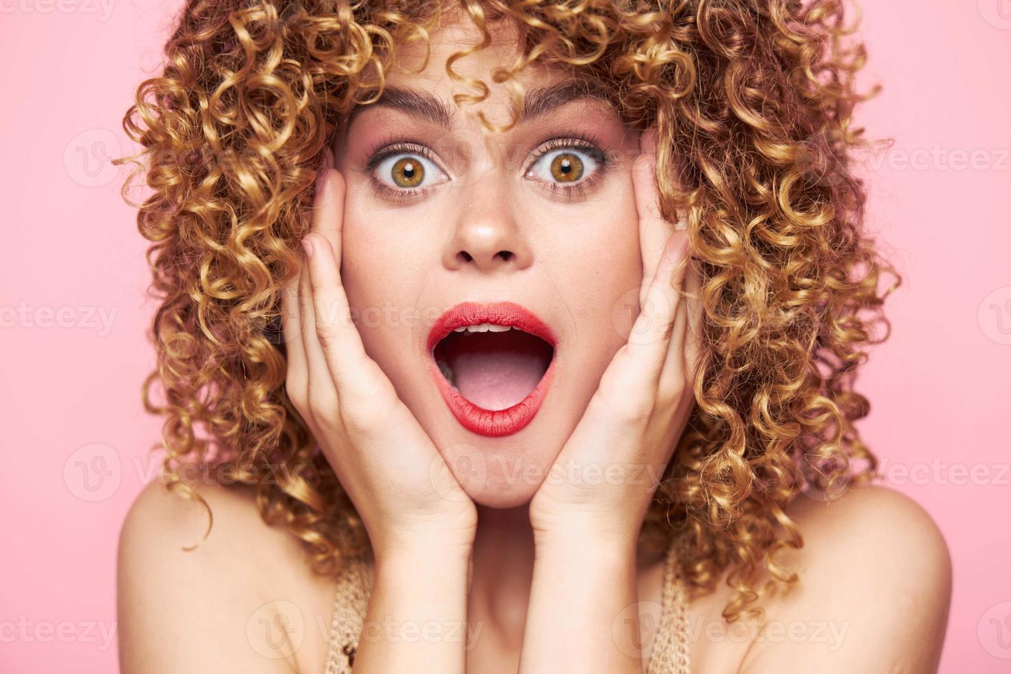 Charming model Astonished look wide open mouth curly hair bright makeup photo