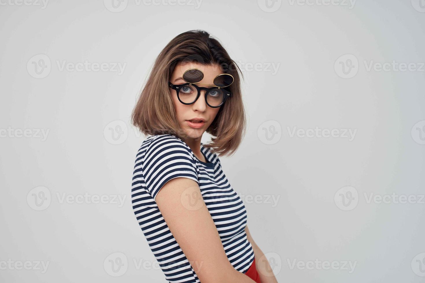 woman wearing fashion glasses striped t-shirt light background glamor photo