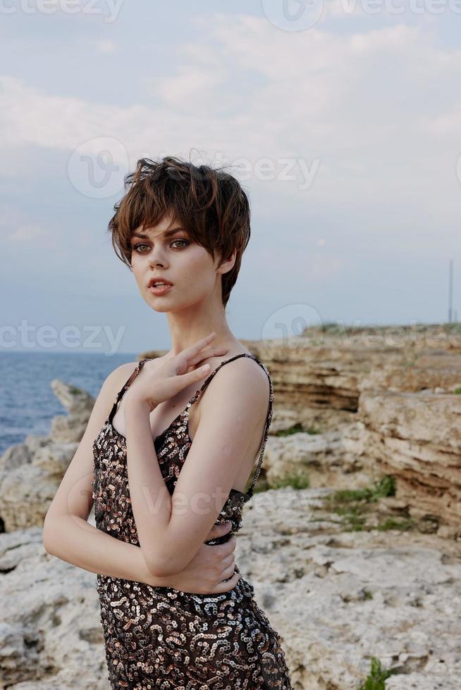 woman with makeup in dress on nature rocks landscape outdoors photo