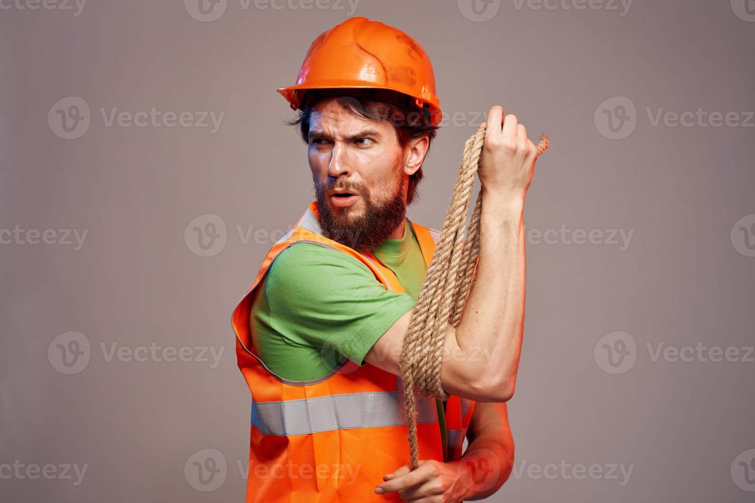 Male builder orange hard hat work Professional gray background photo