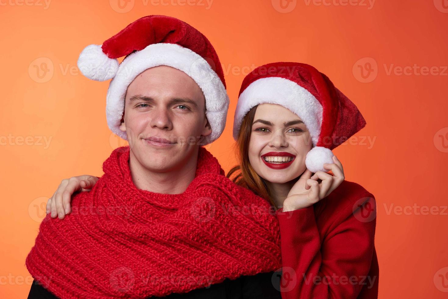 funny man and woman christmas santa hat friendship red background photo