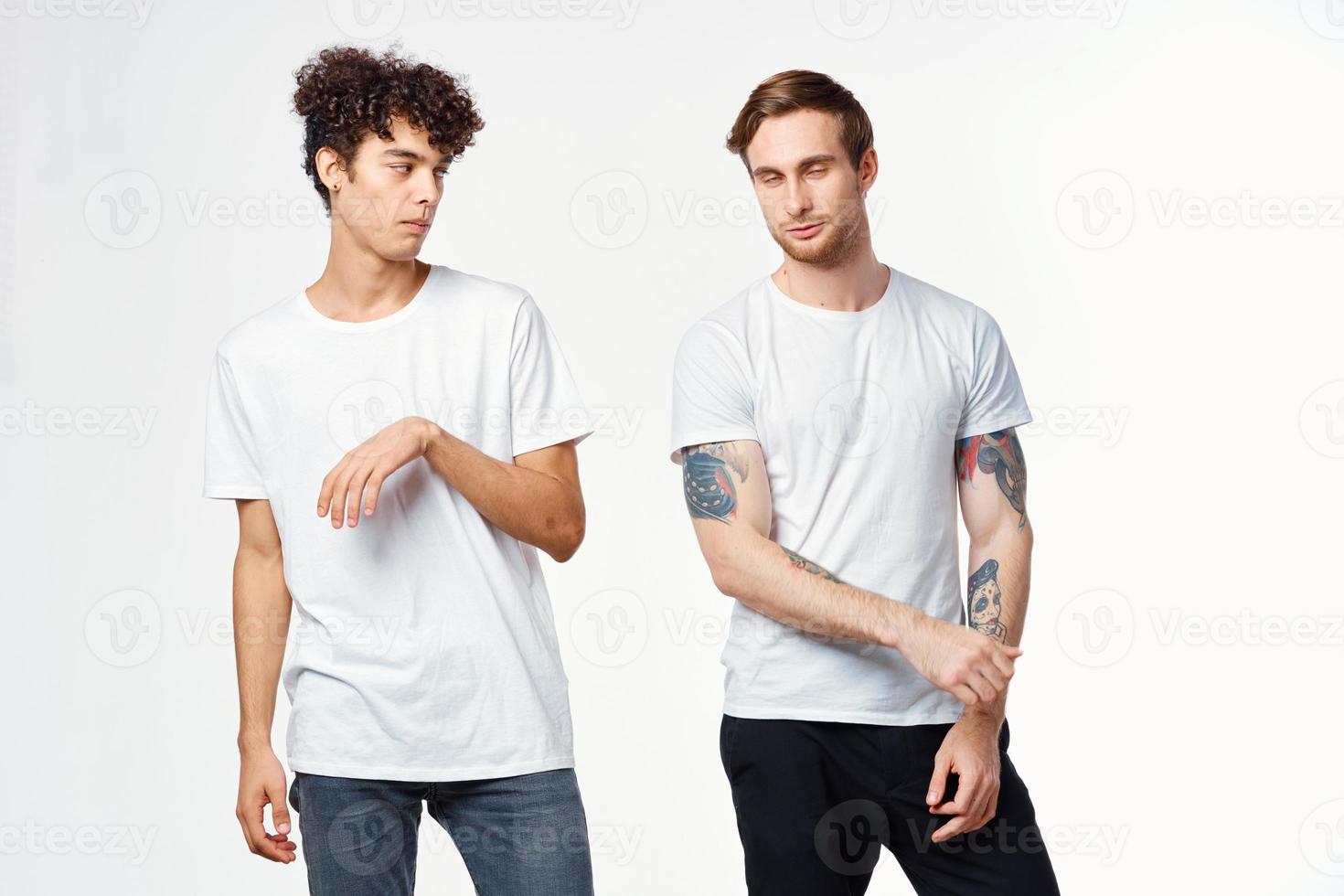 Two cheerful friends in t-shirts stand side by side photo