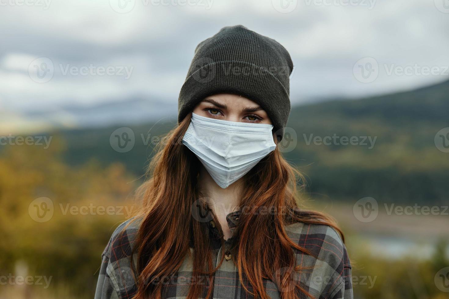 Woman in medical mask nature autumn yellow leaves on trees photo
