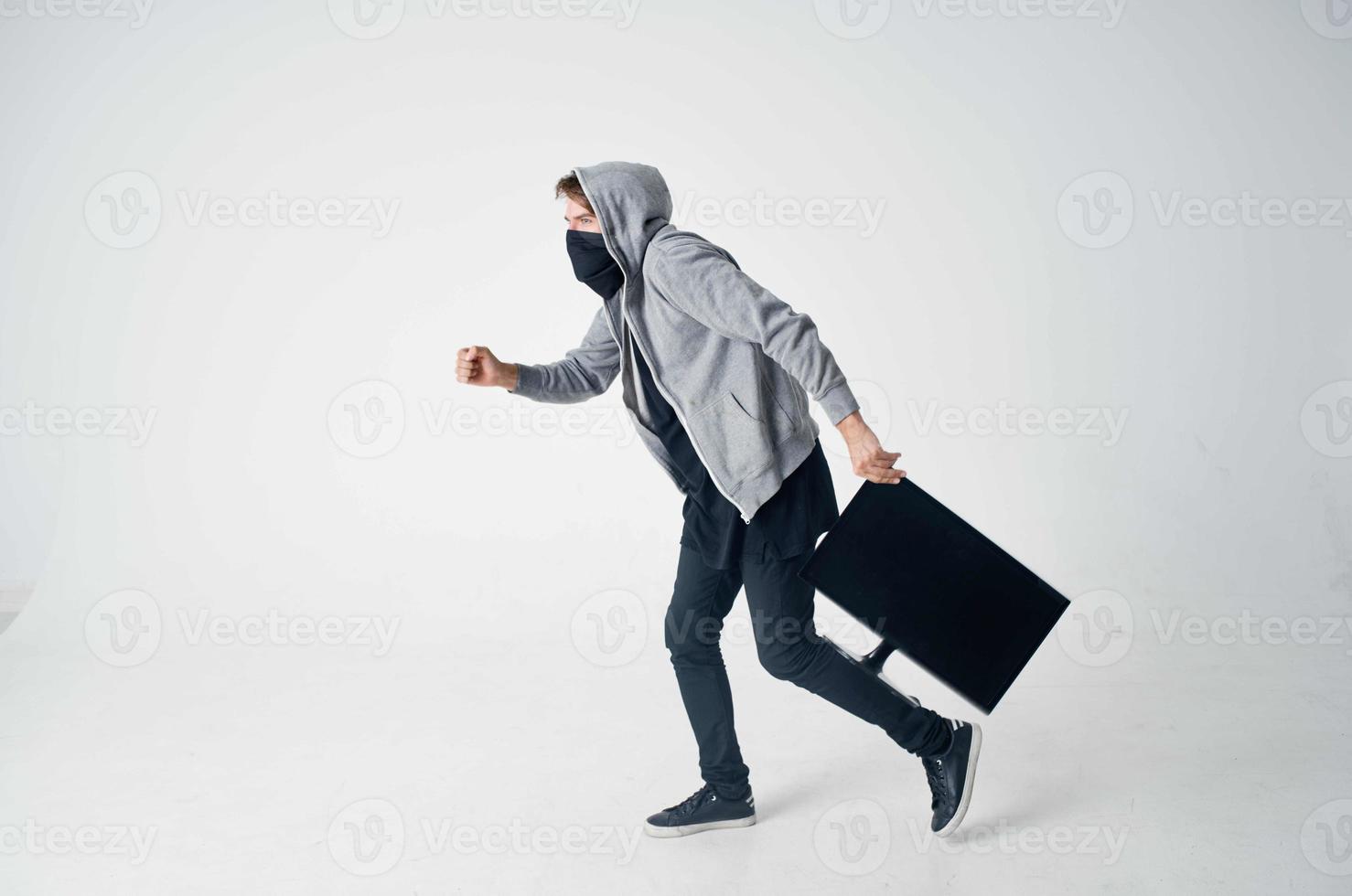 hacker crime anonymity caution balaclava light background photo