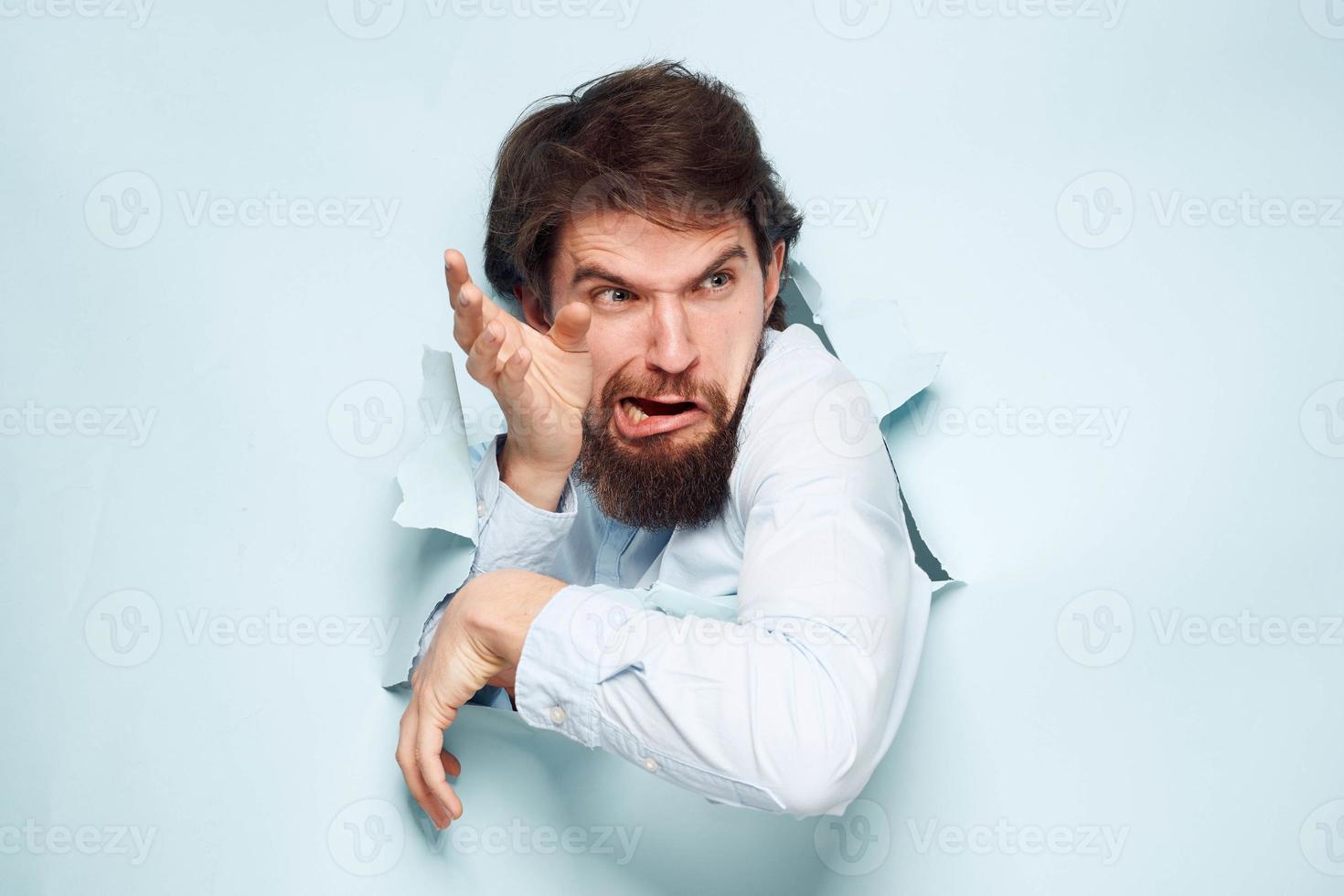 Emotional man breaks through the wall of emotions career work finance photo