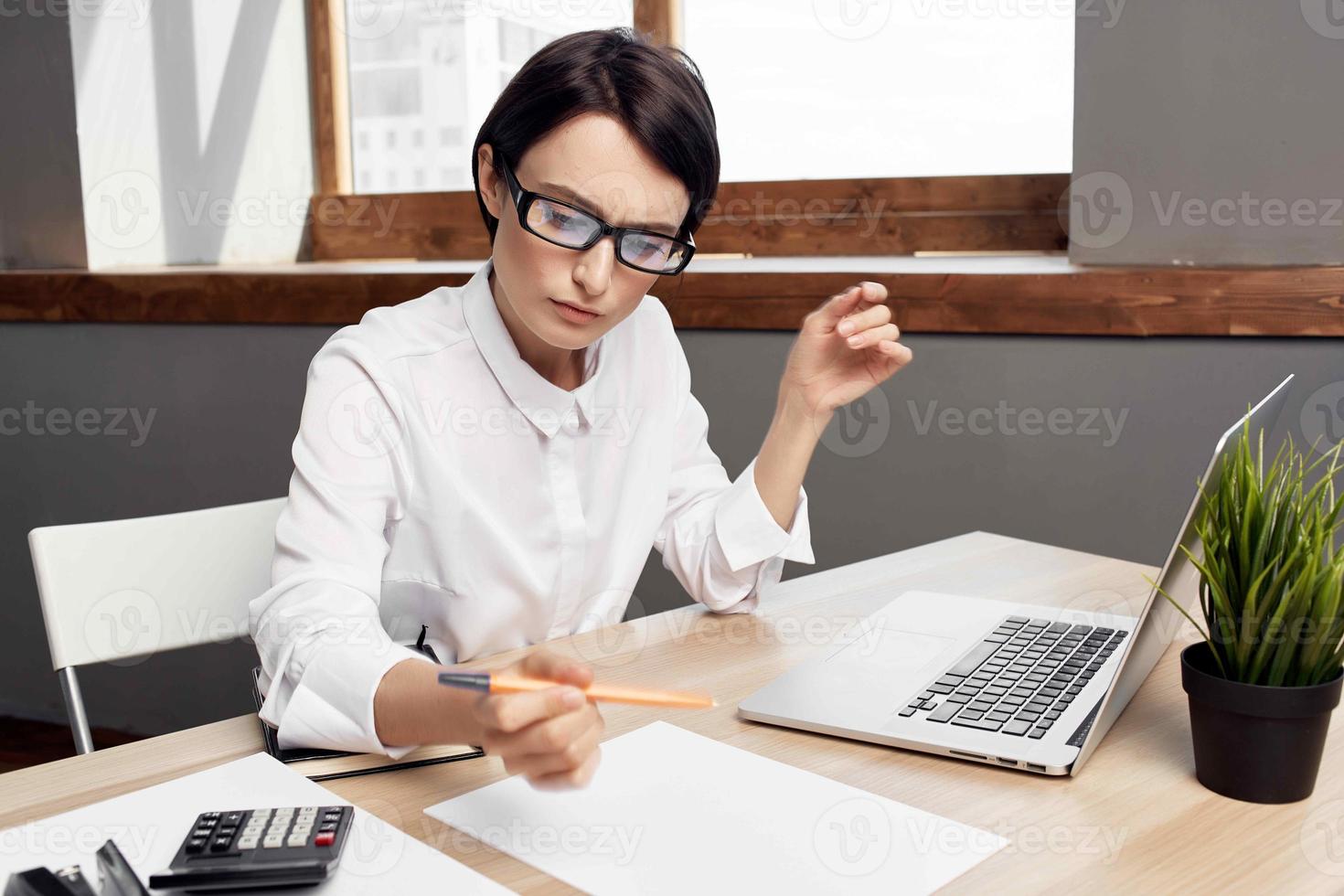 Businesswoman at the desk Secretary executive light background photo