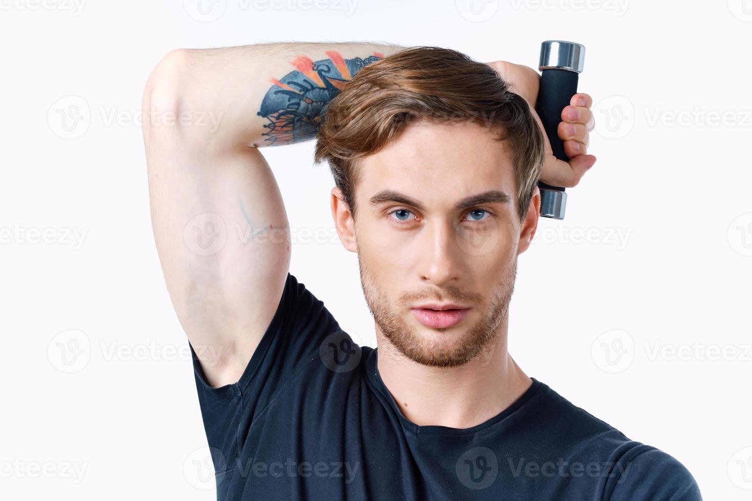 man with pumped up arm muscles fitness workout black tshirt dumbbells