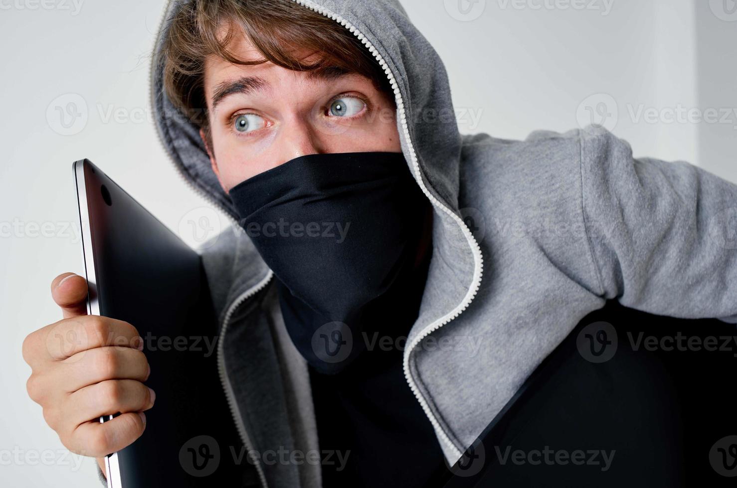 masked man crime anonymity caution balaclava light background photo