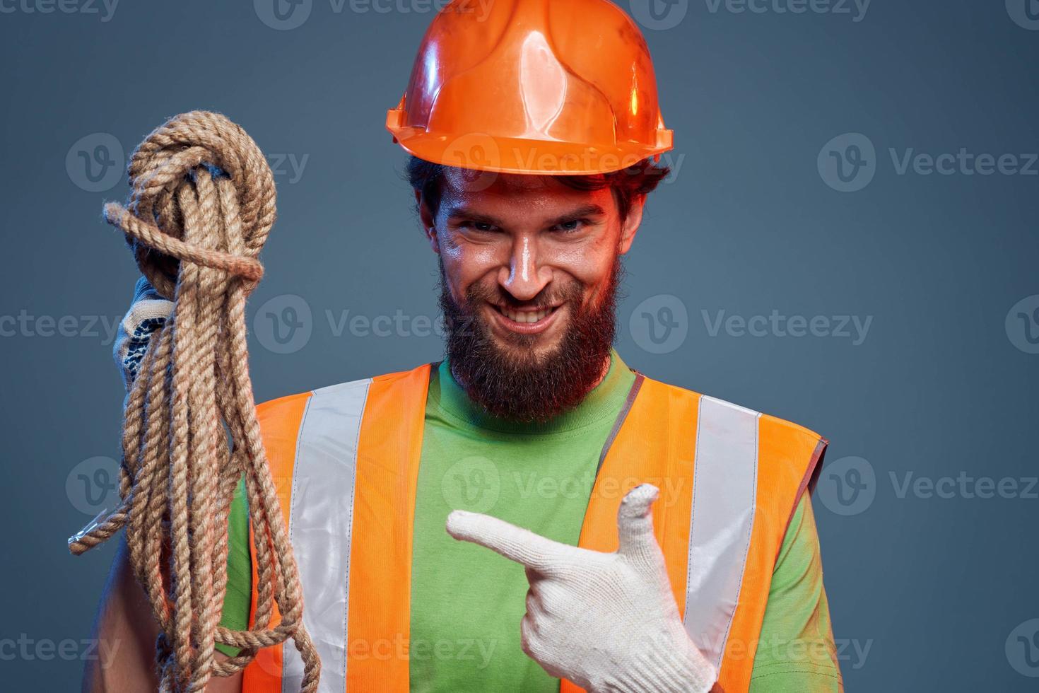 Emotional man in work uniform orange helmet rope professional photo