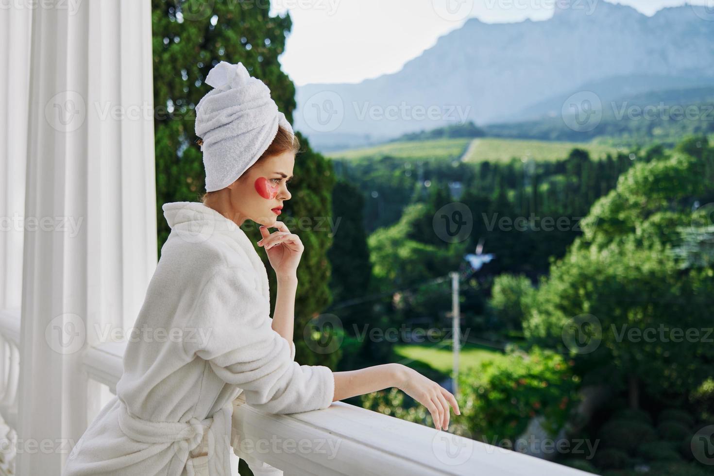 Portrait woman in a white robe the balcony overlooks the mountains unaltered photo