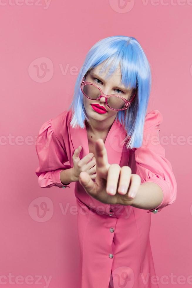 fashionable woman in sunglasses wears a blue wig makeup isolated background photo