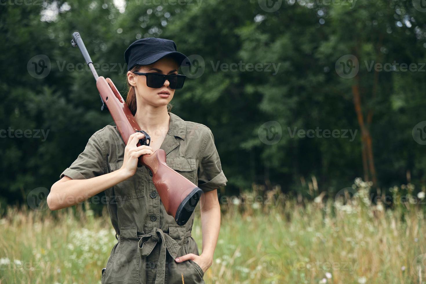 Woman on outdoor Hunting walk with weapons in dark glasses weapons photo