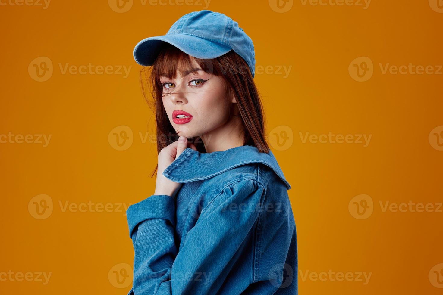 Portrait of a charming lady denim clothing fashion posing cap color background unaltered photo