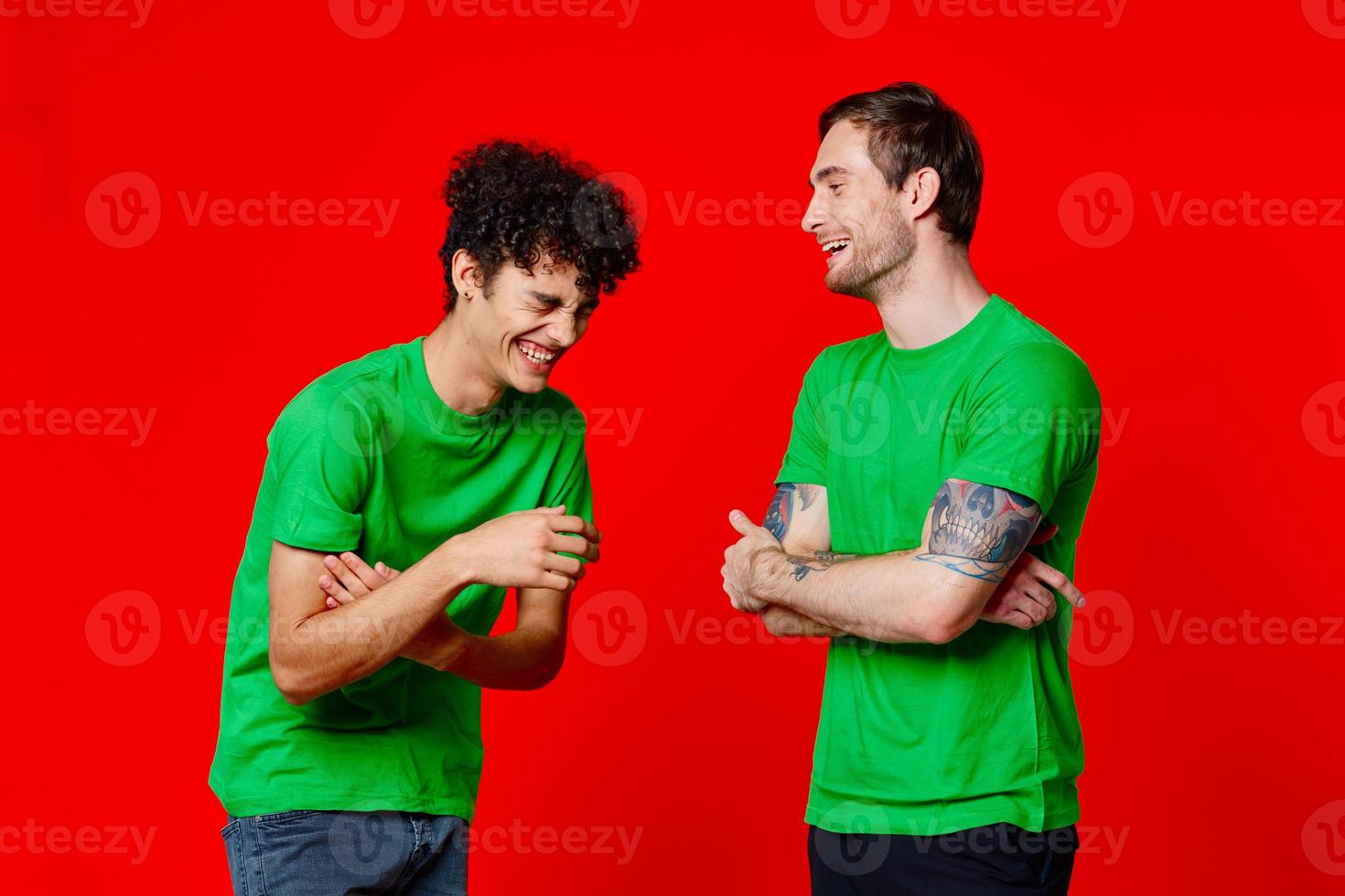 Cheerful friends are standing next to communication fun red background photo