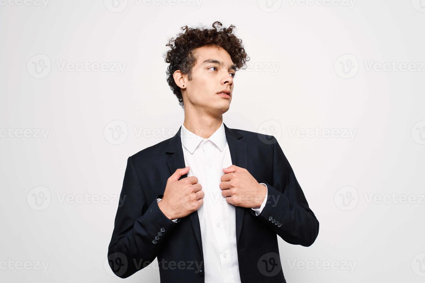 curly-haired guy in a suit black jacket self-confidence photo