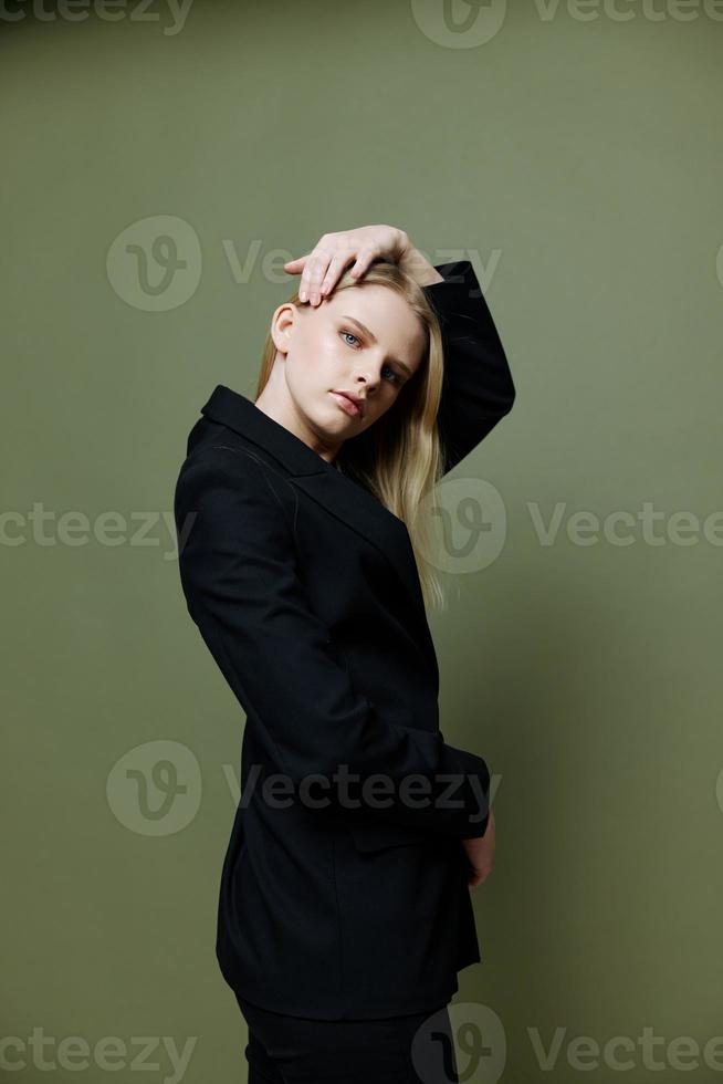 Cool banner for brands. An attractive cool professional model poses in a half-turn and looks at the camera on a green olive background in the studio photo