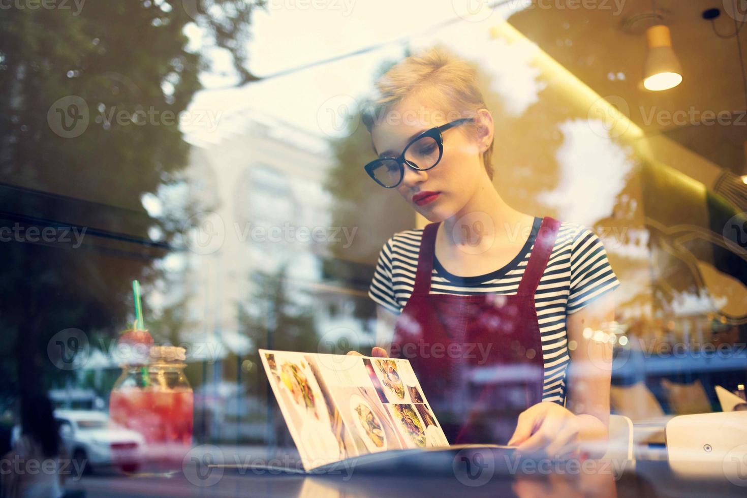 woman alone sitting in a restaurant cocktail vacation dreamy look photo
