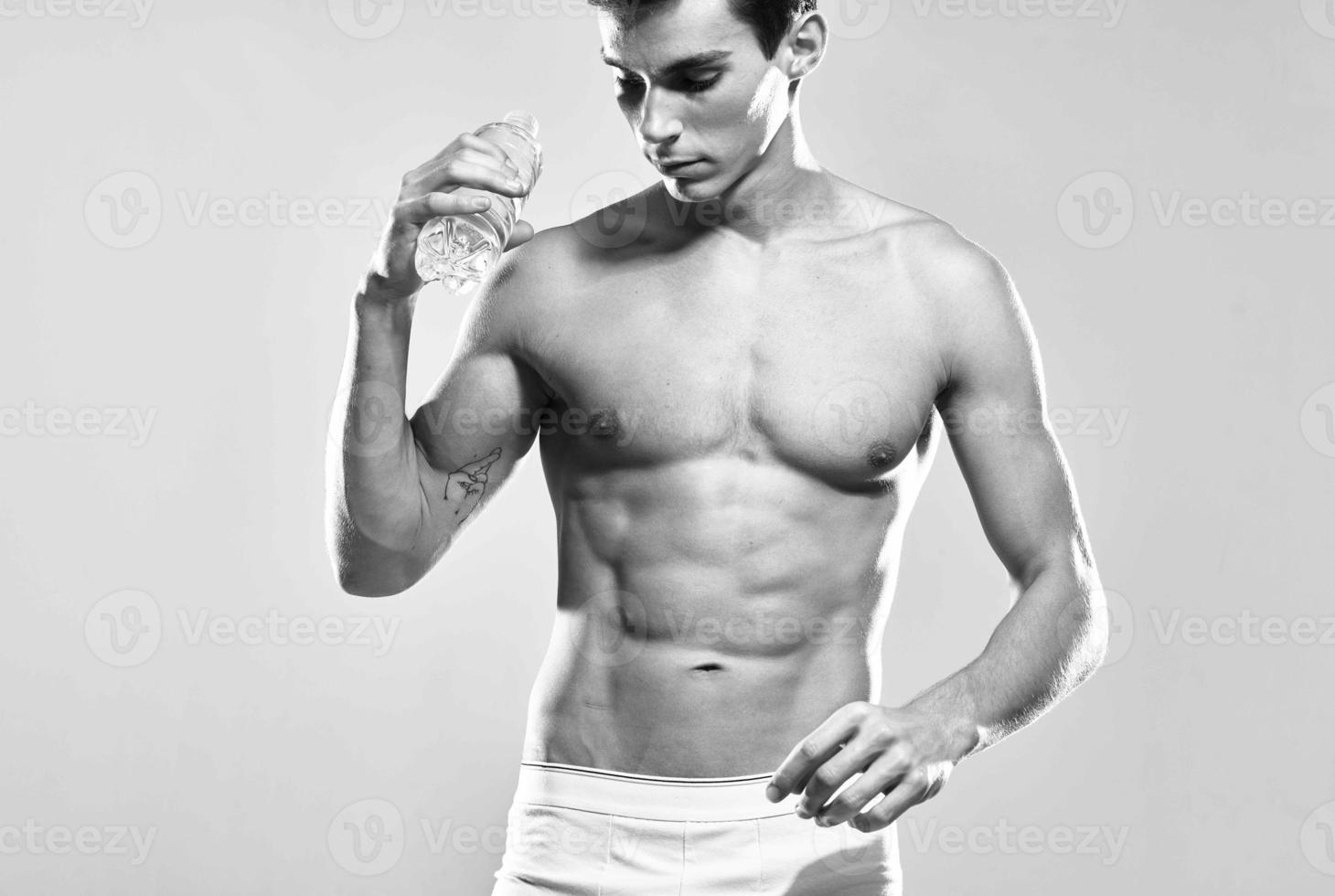 athletic man water bottle muscular body studio posing photo