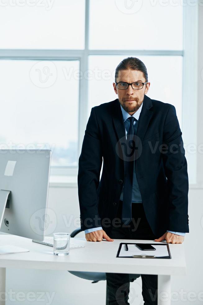 el hombre en un traje cerca el escritorio trabajo proceso estilo de vida foto