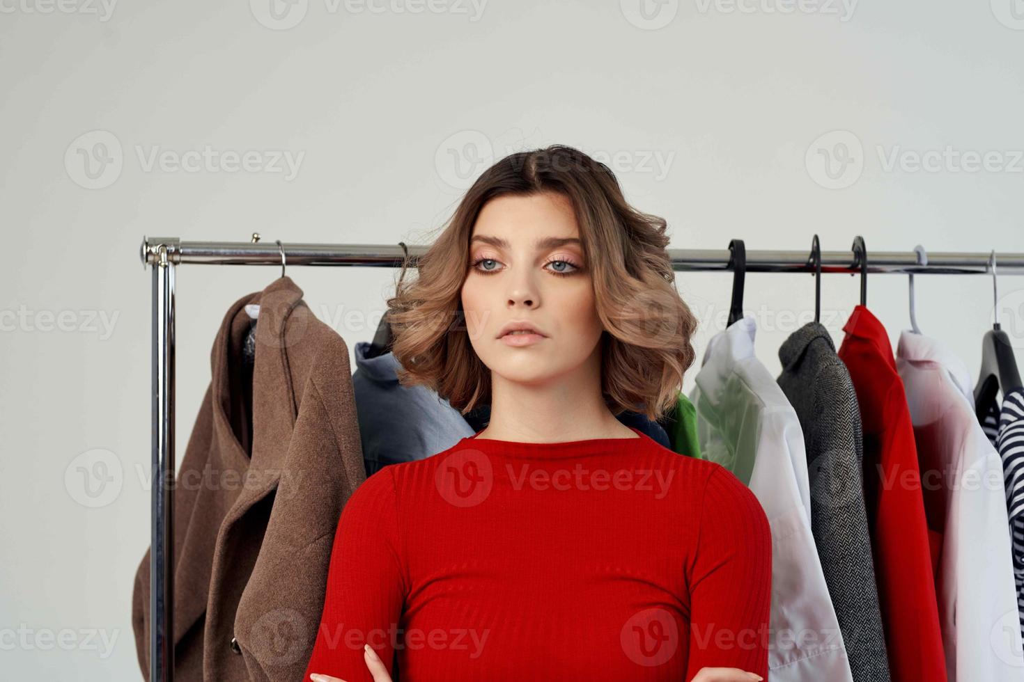 cheerful woman next to clothes fashion fun retail emotions photo