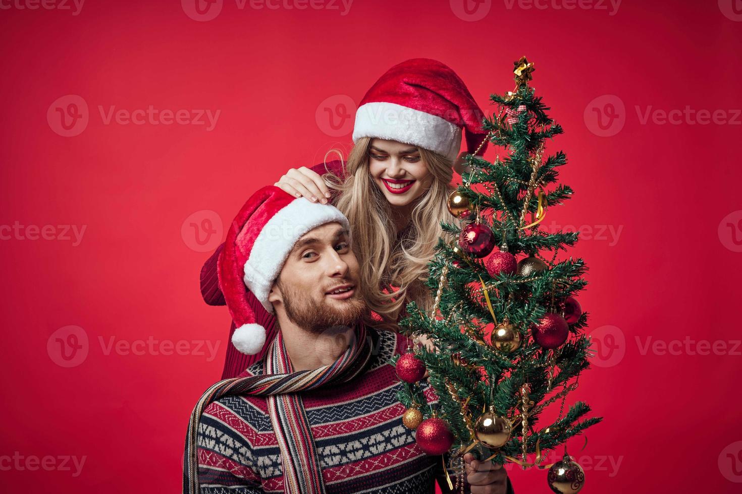 Cheerful young couple New Year in a place of Christmas holiday photo