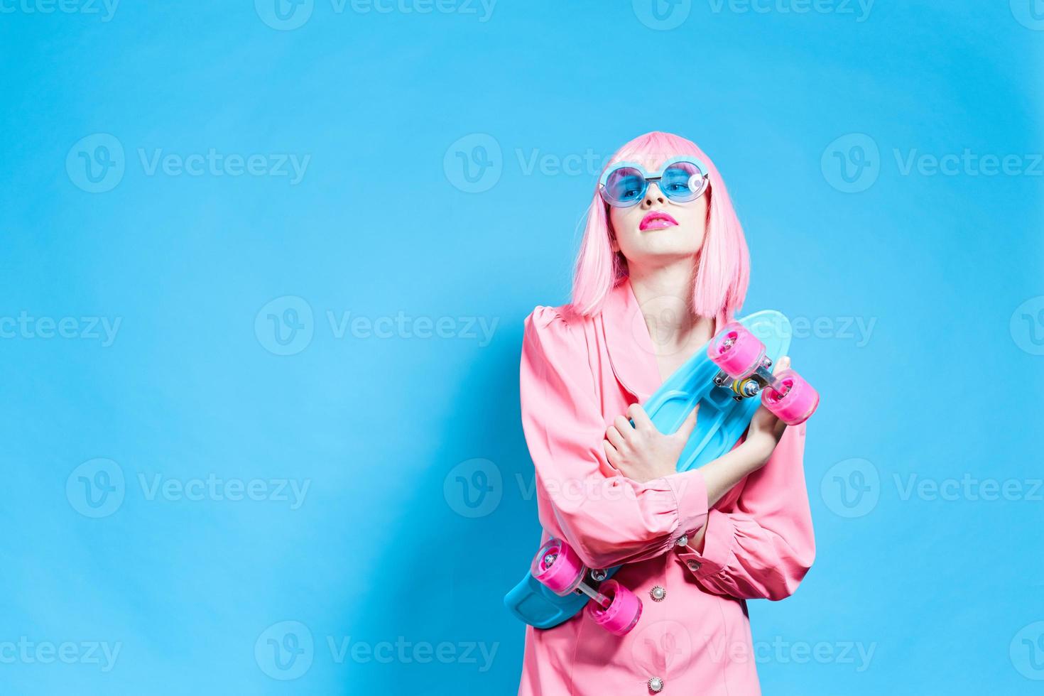 glamorous woman in sunglasses wears a pink wig isolated background photo