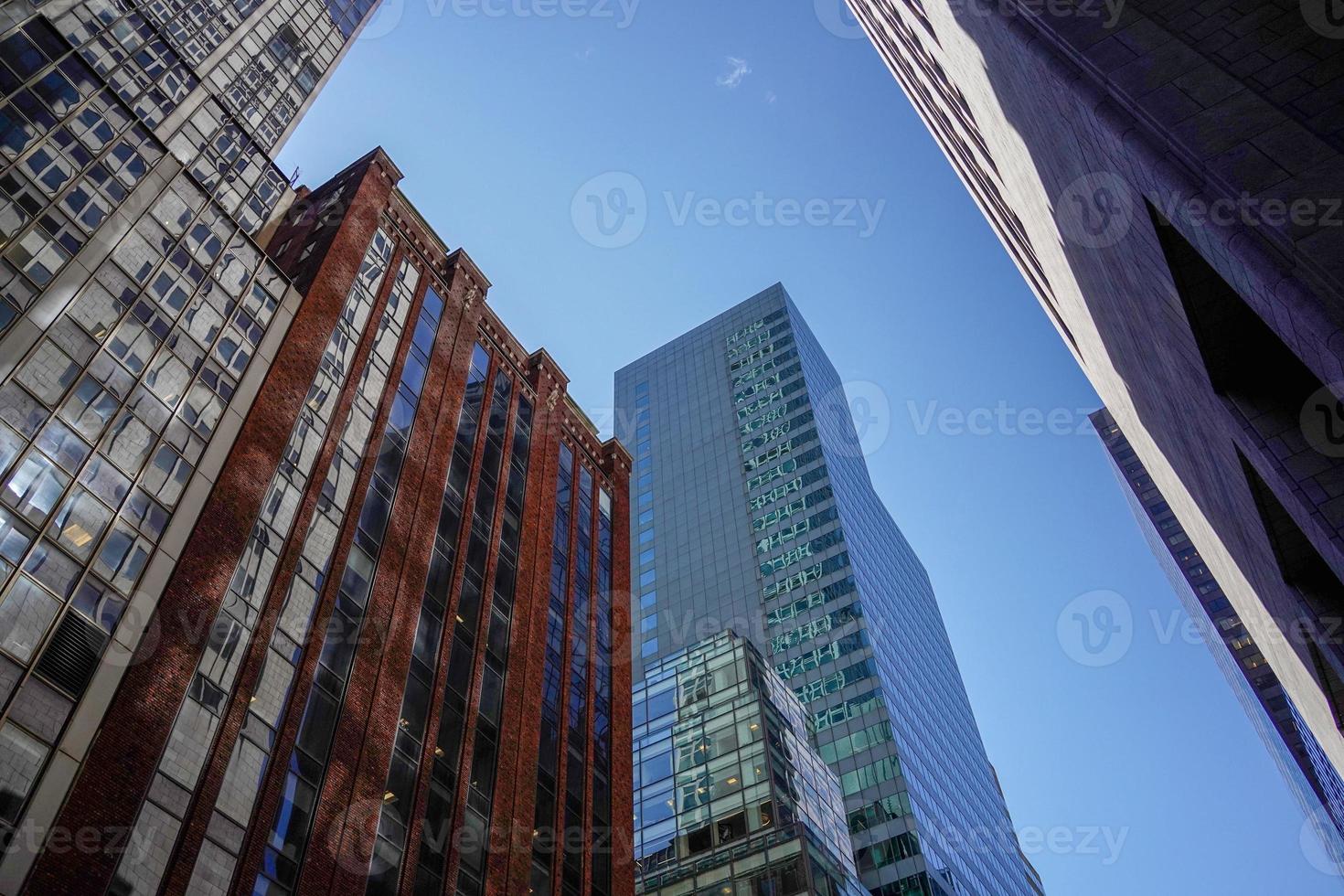 new york manhattan skyscrapers view from the street to the top of the building on sunny clear day photo