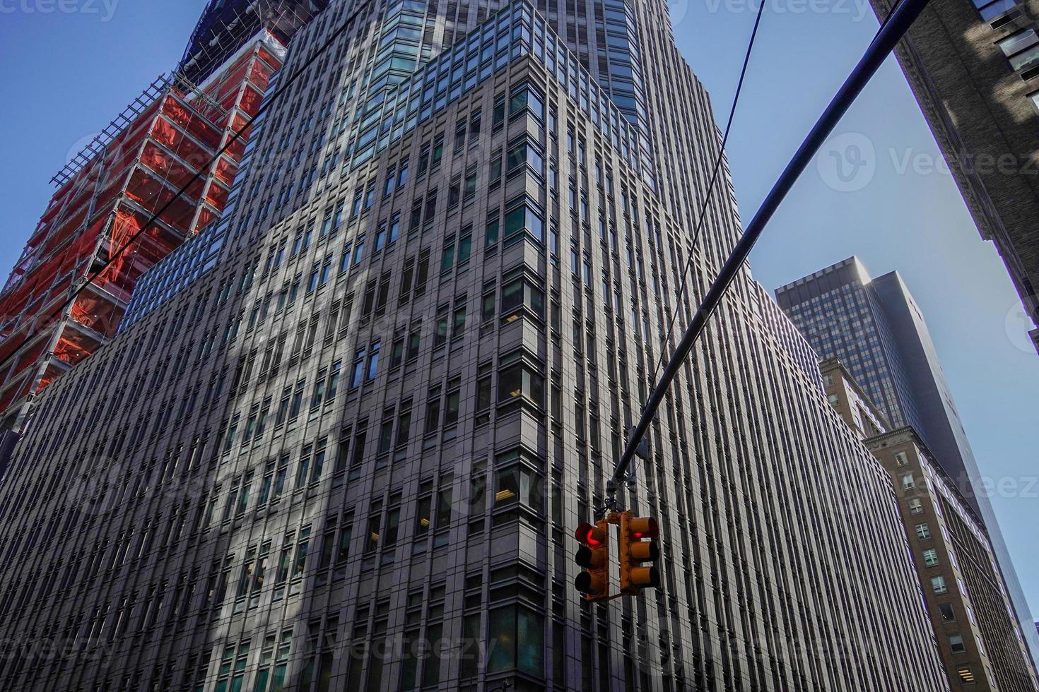 traffic light new york manhattan skyscrapers view from the street to the top of the building on sunny clear day photo