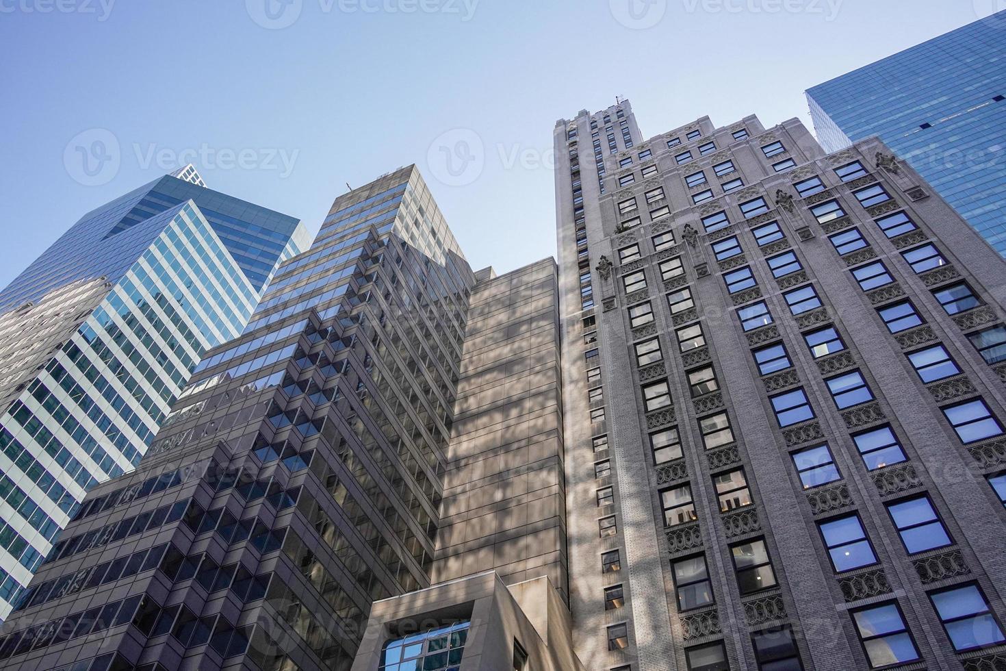 new york manhattan skyscrapers view from the street to the top of the building on sunny clear day photo