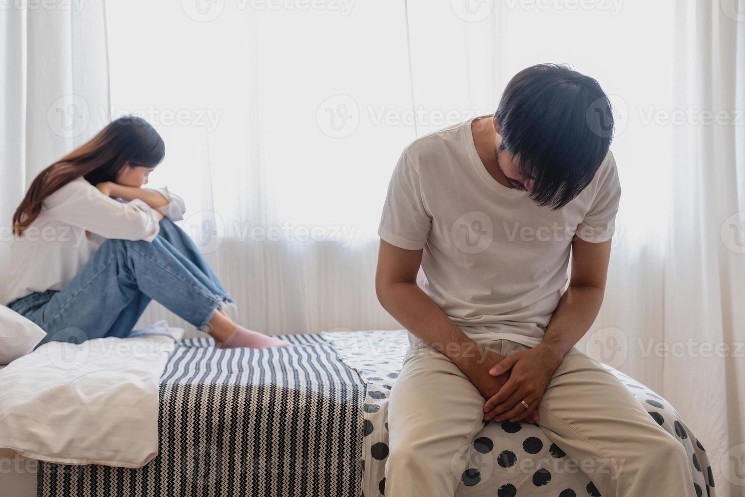 The husband is unhappy and disappointed in the erectile dysfunction during sex while his wife sleeping on the image photo