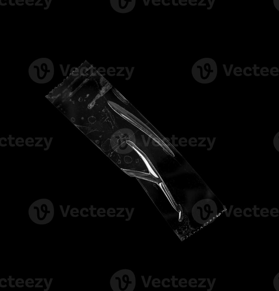 adhesive plastic tape isolated on black background photo