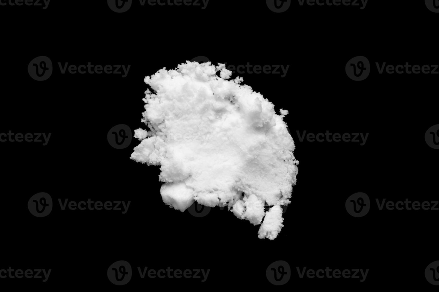 White snow isolated on black background close up photo