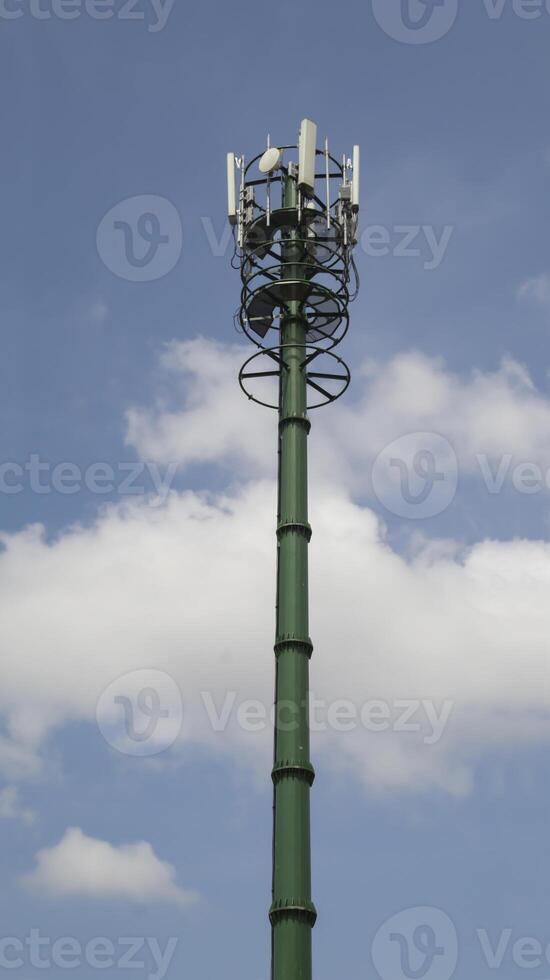 Mobile phone area transmitter or 4G base station communication tower sky background. photo