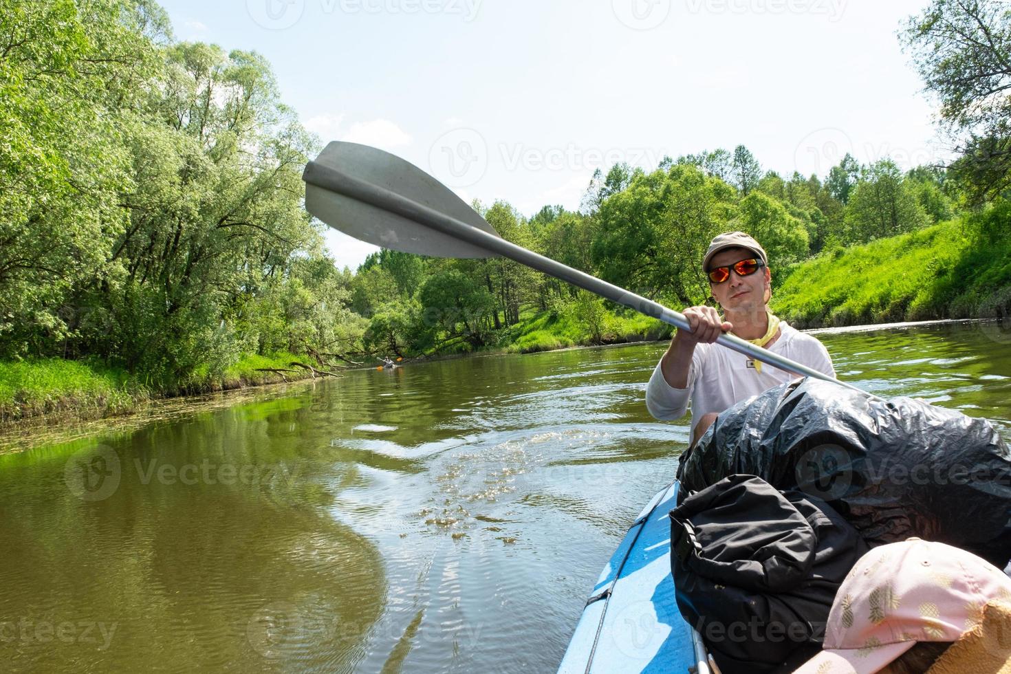 Family kayak trip. Father and daughter rowing boat on the river, a water hike, a summer adventure. Eco-friendly and extreme tourism, active and healthy lifestyle photo