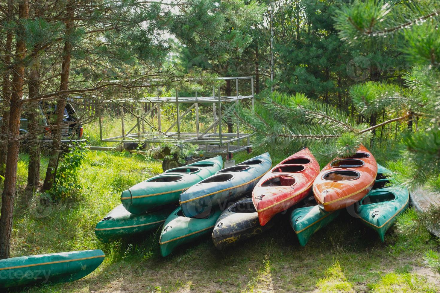 There are a lot of kayaks for a water hiking trip in a large group. Boat delivery and transportation, tourist service on a commercial trip photo