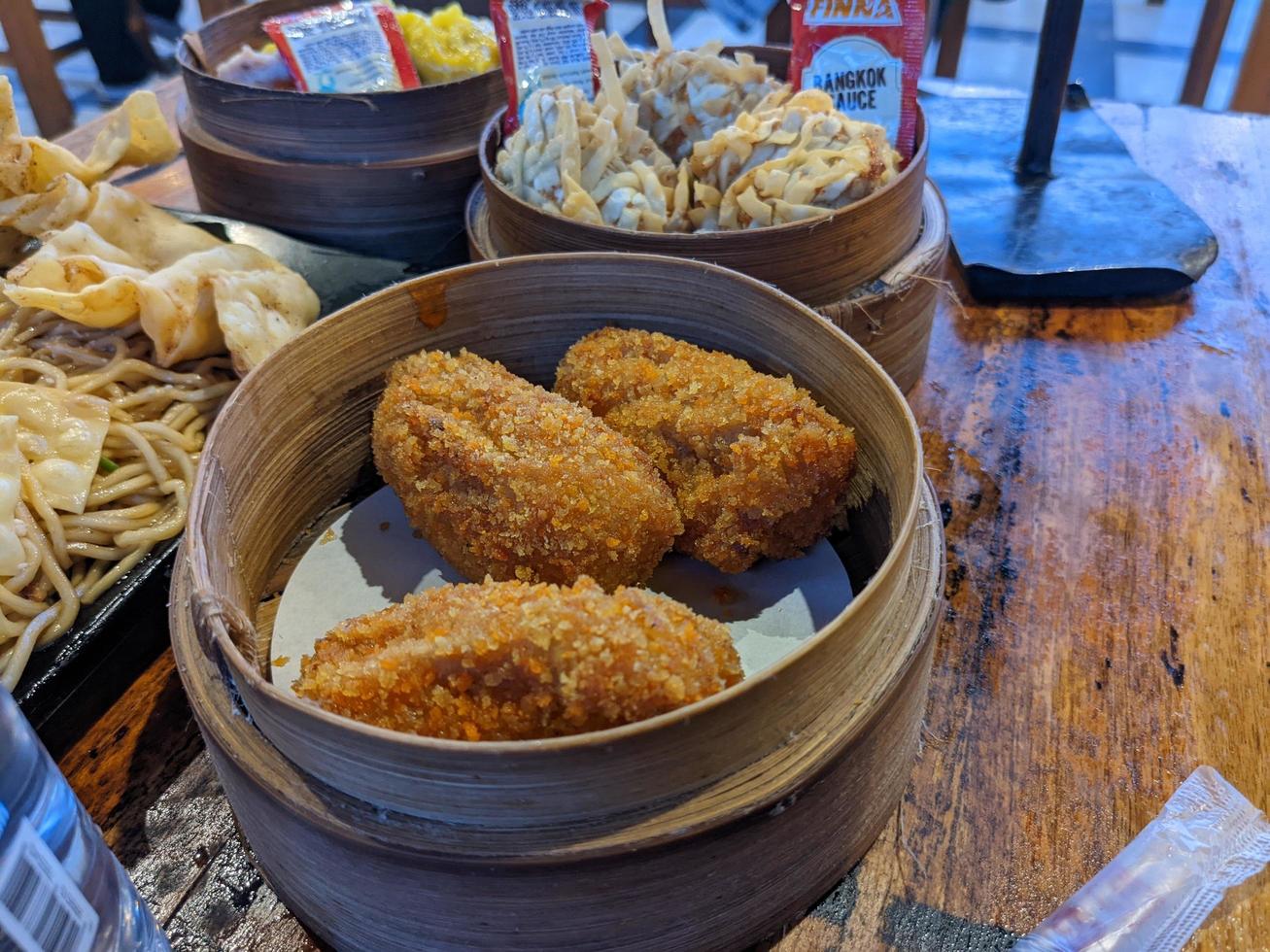 Cheese shrimp on the bamboo bucket and the dimsum traditional food from chinese. The photo is suitable to use for Chinese traditional food background, poster and food content media.