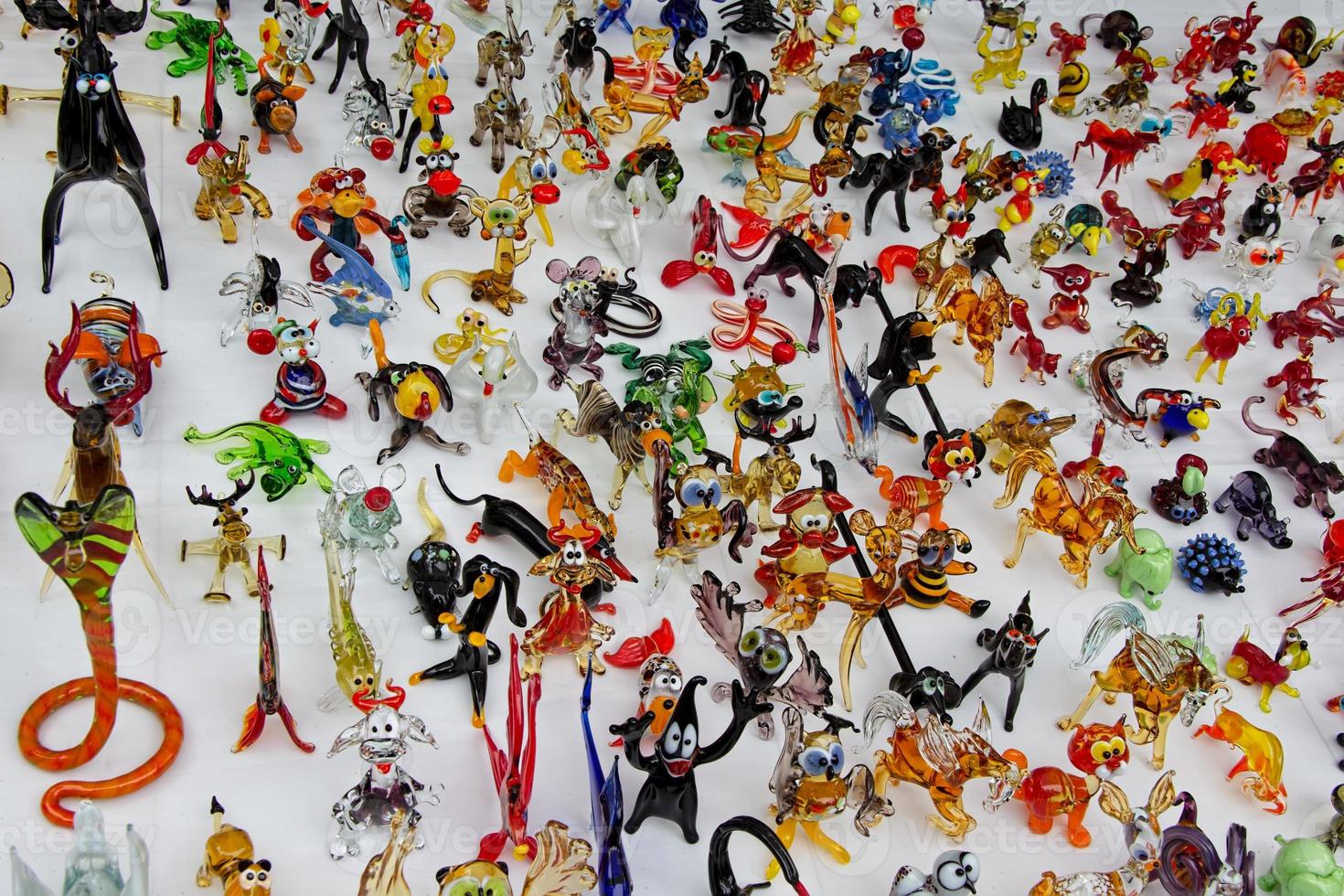 A large number of various toys made of glass. photo