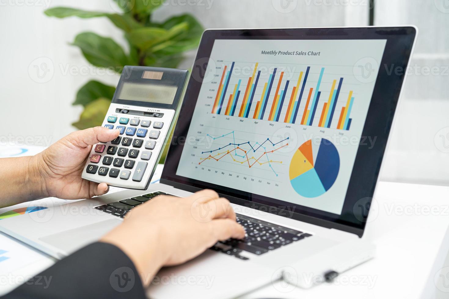 Asian accountant working and analyzing financial reports project accounting with chart graph in modern office, finance and business concept. photo