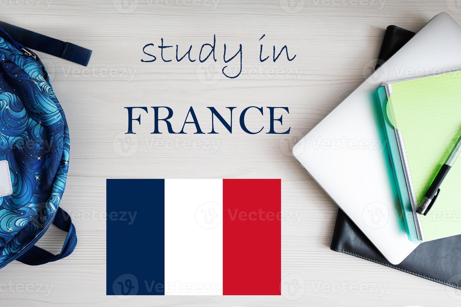 Study in France. Background with notepad, laptop and backpack. Education concept. photo