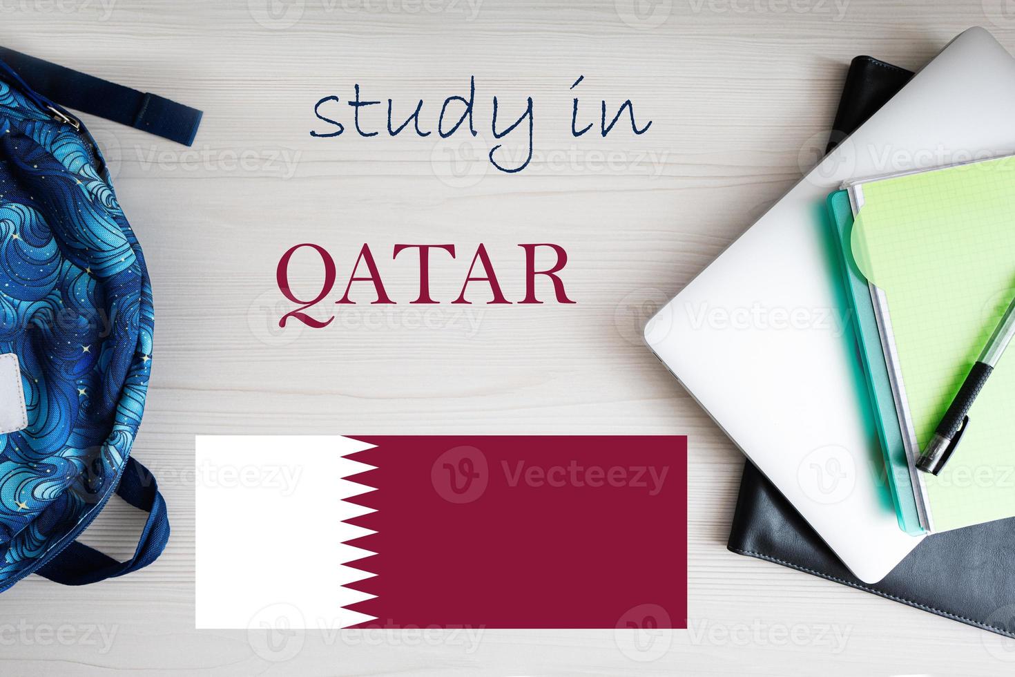 Study in Qatar. Background with notepad, laptop and backpack. Education concept. photo