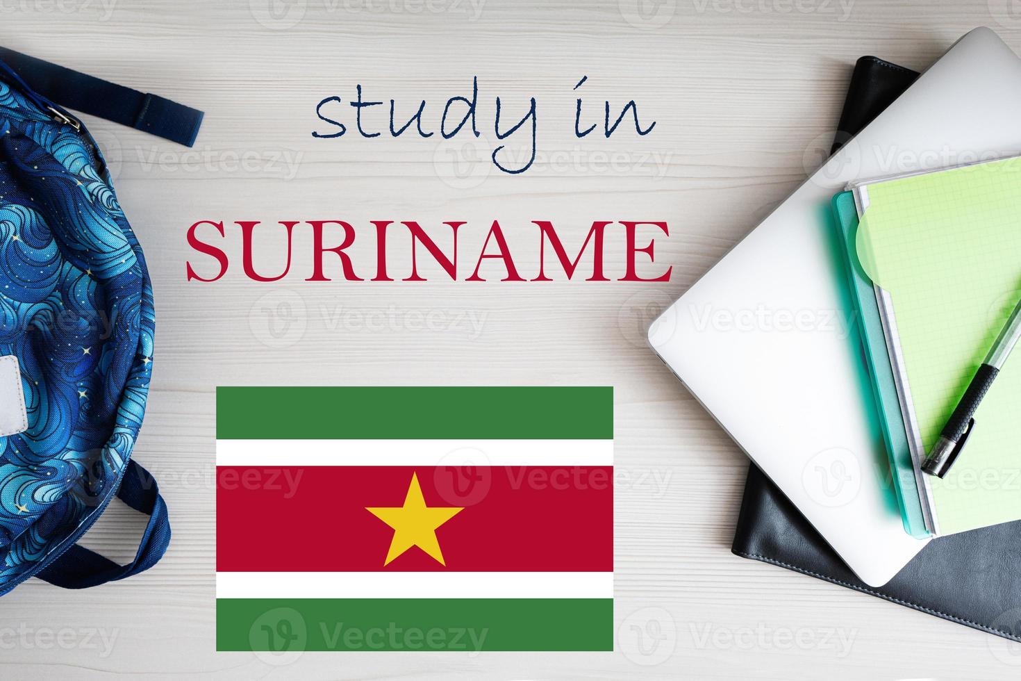 Study in Suriname. Background with notepad, laptop and backpack. Education concept. photo