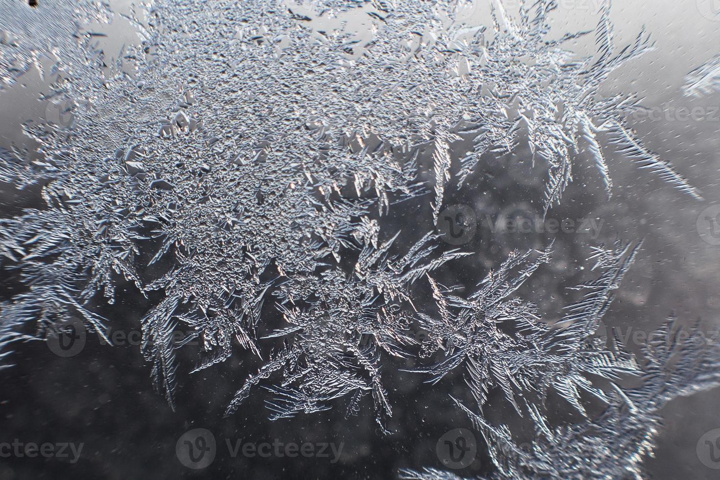 snow pattern on the glass from frost photo