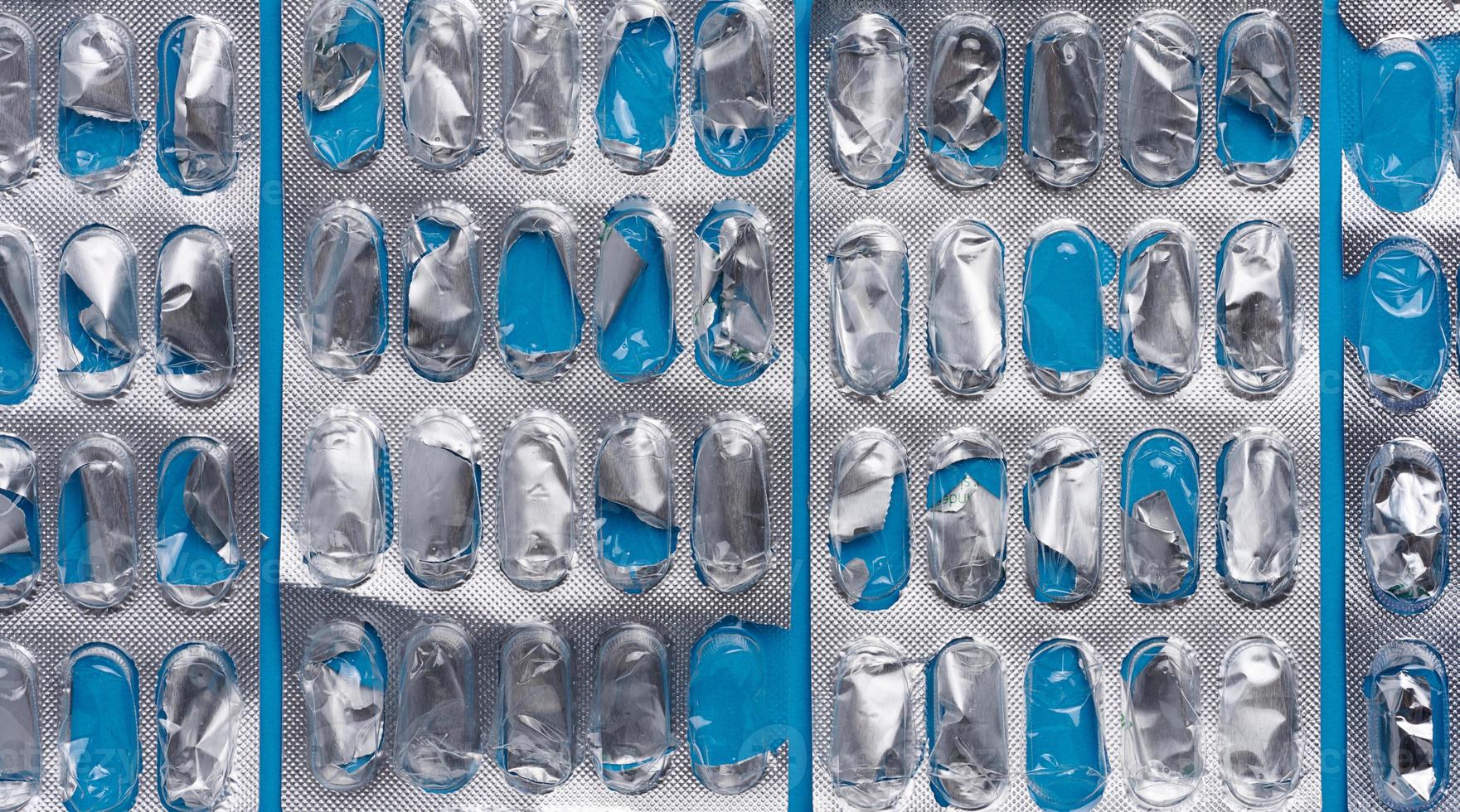 Empty blister pack of capsules on a blue background, close up photo