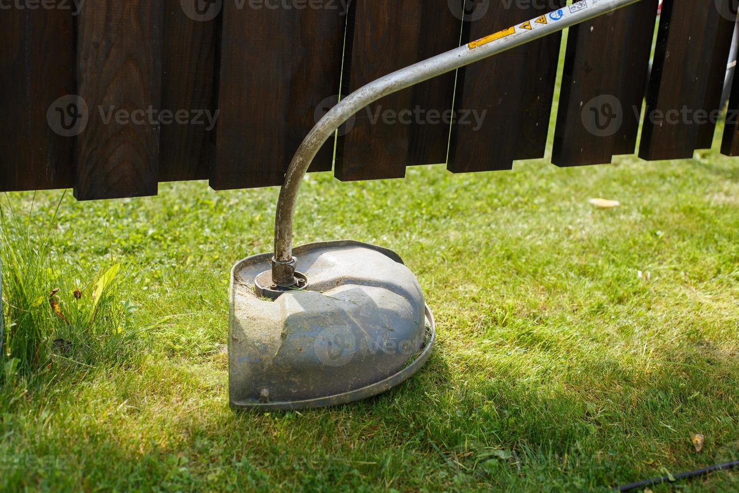 a man mows grass with a trimmer outdoor photo
