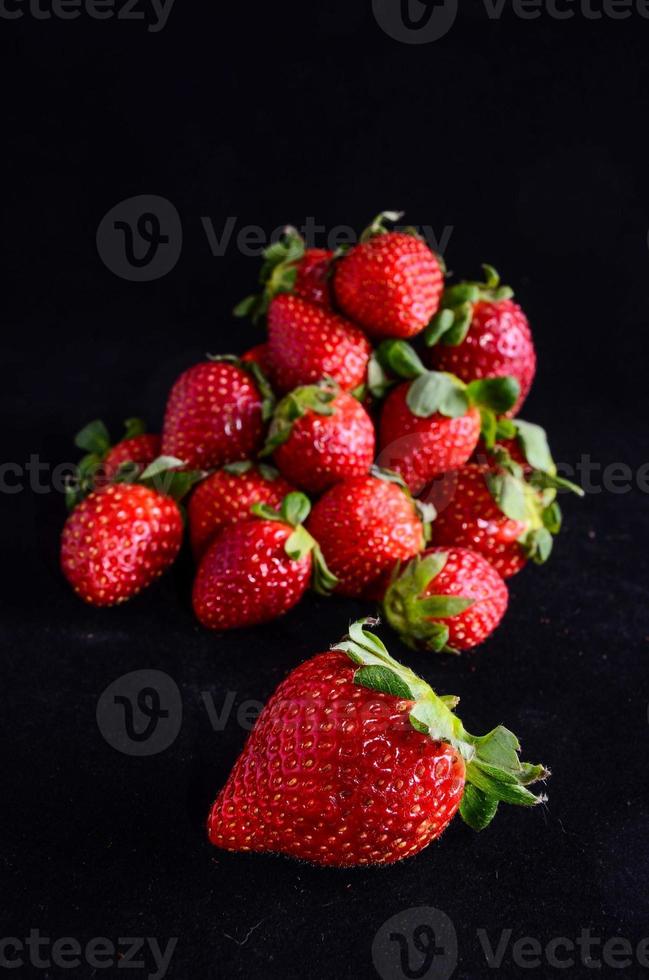 Strawberries on black background photo